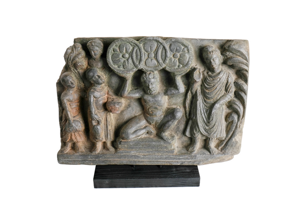Schist Panel with Atlas holding the Three Wheels  - Gandhara - 200/300 AD